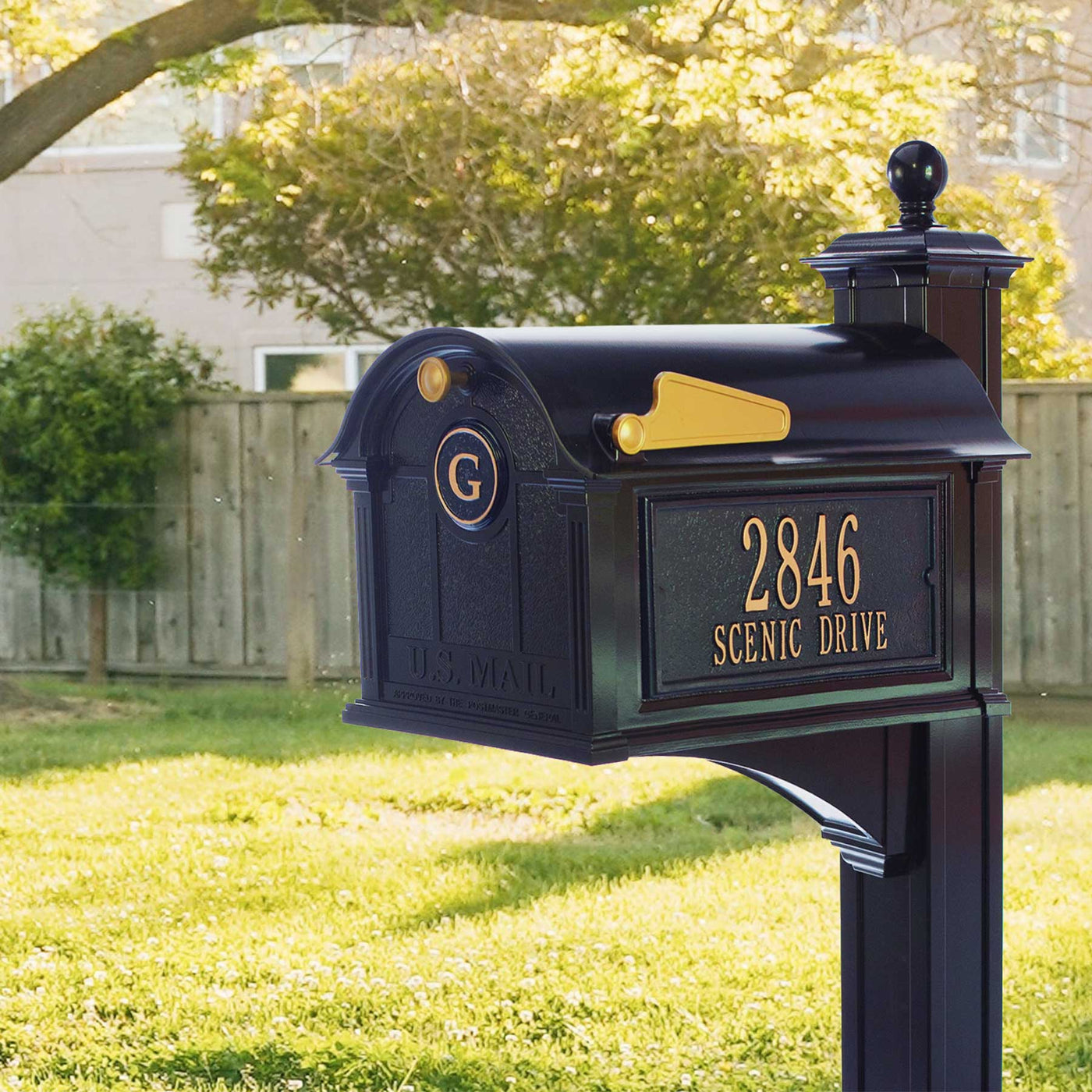high quality residential decorative black mailbox with monogram letter plaque on the front and address plaque on the side details in gold accent
