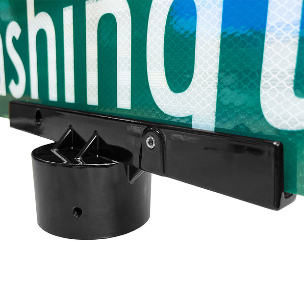 Large post top sign mounting hardware. Powder-coated black and shown holding a traffic green reflective street-blade.