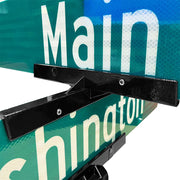 Large cross hardware. Shown mounting two street-blades stacked perpendicular. Hardware is powder-coated black and shown holding two traffic green reflective street-blades