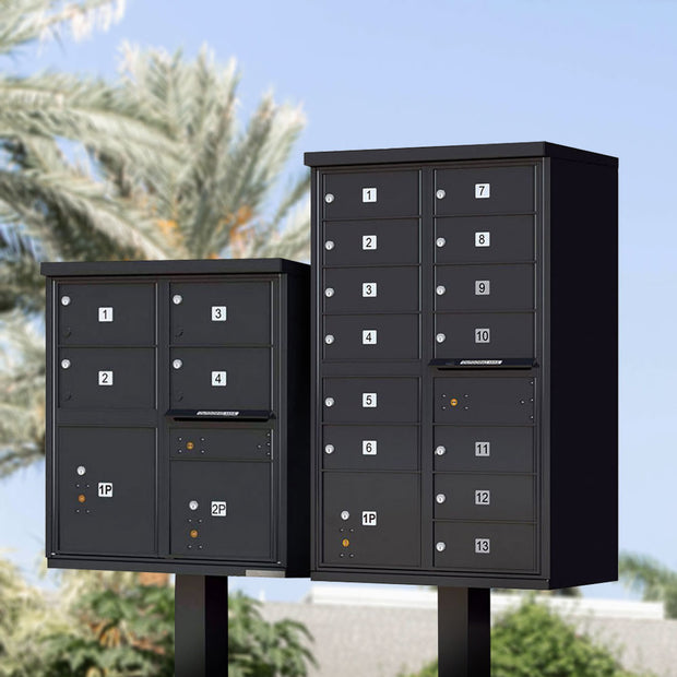 Two Florence Vital 1570 Series CBU Mailboxes in black. The USPS cluster mailbox on the right is a 4 unit, type 5 with 2 secure parcel doors. The CBU on the left is a 13 unit, type 4 with one parcel door. Both include a mail slot and have standard silver tenant door ID numbers. Models 1570-4T5 and 1570-13