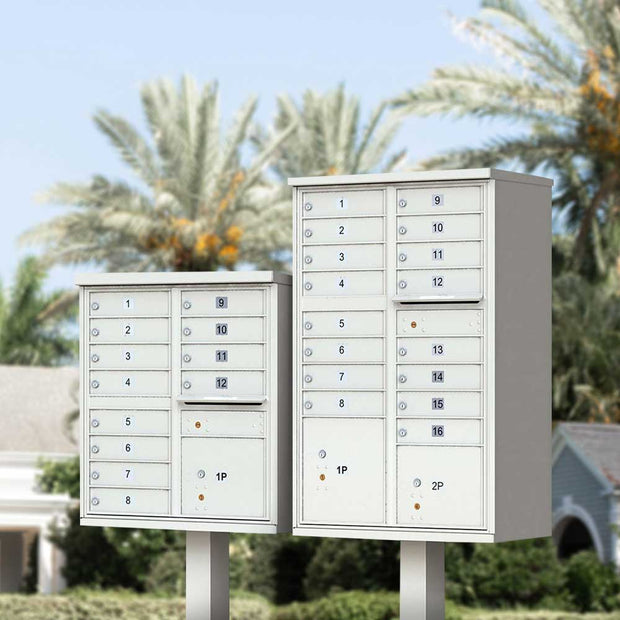 Two Florence Vital 1570 Series CBU Mailboxes in white. The USPS cluster mailbox on the right is a 12 unit, type 2. The CBU on the left is a 16 unit, type 3. Both include a mail slot and have standard silver tenant door ID numbers. Models 1570-12 and 1570-16