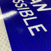 close up of blue printed on reflective white HIP vinyl