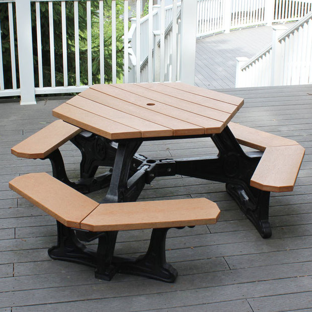 plaza hexagon recycled picnic table with cedar top and black base, placed on a deck