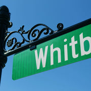 Image of street sign installed with a decorative hanger arm on a street post
