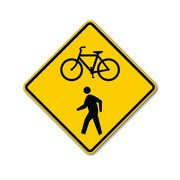 caution sign in yellow background with bike symbol and pedestrian symbol printed in black and black thick border, diamond shaped sign with rounded corners
