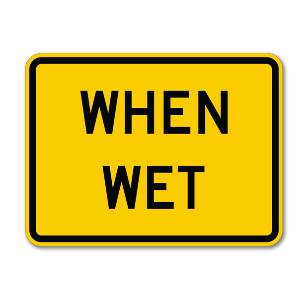 yellow and black caution sign with text reading " when wet" for wet road warning