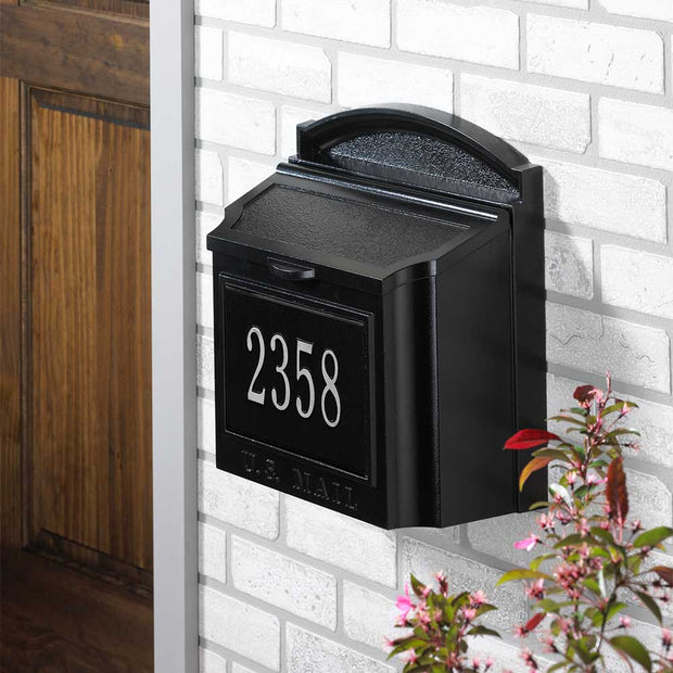 whithall cast aluminum wall mailbox in black with plaque in black and silver mounted on brick exterior of house by door