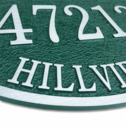 14" x 10" oval aluminum door number plaque with green finish, angled to show texture