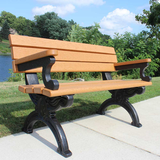 Silouette style park bench made of recycled plastic with cedar top color and black base color.