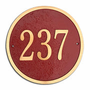 A round address plaque made from cast bronze
