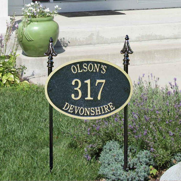 An example of a lawn-mounted house number plaque with custom finials