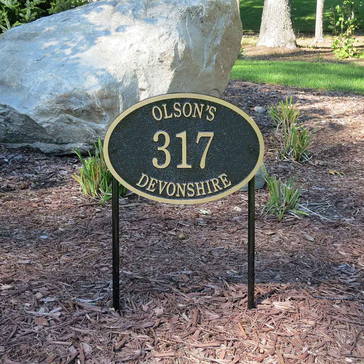 A lawn mounted address plaque using stakes